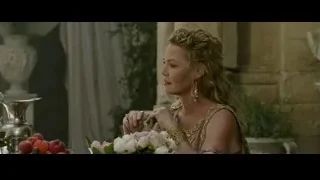 woman in gold dress with flowers — Gladiator 2