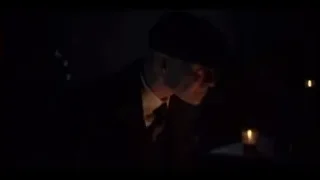 Man in hat standing in candlelit room — Peaky Blinders