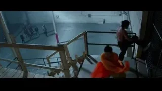 man in orange robe holding red flag — Bruce Lee: Birth of The Dragon