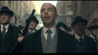 men in suits with guns walking down street — Peaky Blinders