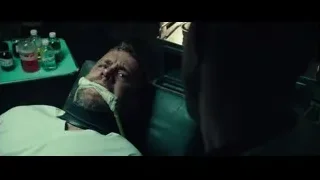 man on hospital bed with mouth bandage — Deadpool