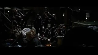 people around campfire in dark tent — Batman: The Dark Knight Rises