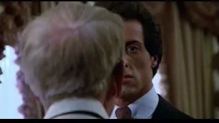 man in dark suit and red tie — Rocky III