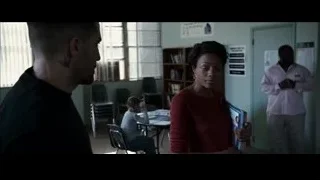 Man and woman in classroom with book — Southpaw