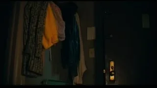 person in dimly lit room with clothes — Joker