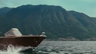 two men on wooden speedboat on lake — Succession