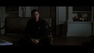 man sitting on bench in dimly lit room — Batman: The Dark Knight Rises
