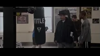 two men punching bag in boxing gym — Creed