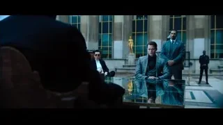 three men in suits at glass table — John Wick: Chapter 4