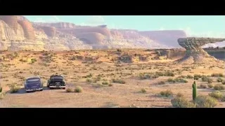 two cars driving in desert landscape — Cars