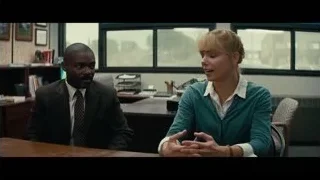 Man and woman conversing at office desk — Interstellar