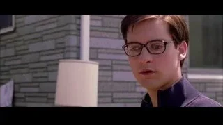 young man with glasses by brick wall — Spider Man 2