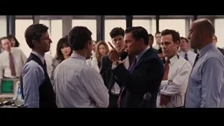 group of men speaking in office — The Wolf Of Wall Street