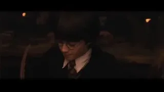 Boy in suit with wand in library — Harry Potter and the Philosophers Stone