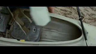 person's hand on backpack in kayak — Into the Wild