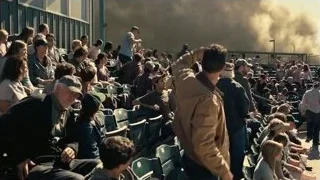 crowd in stadium with smoke rising — Interstellar