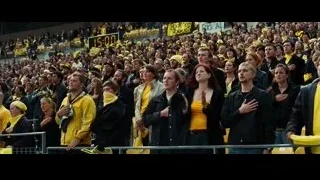 large crowd cheering in stadium — Batman: The Dark Knight Rises
