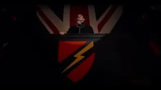 Man speaking at podium with flag — Peaky Blinders