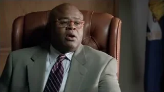 Man in suit speaking in office — Suits
