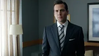Man in suit standing in blue room — Suits