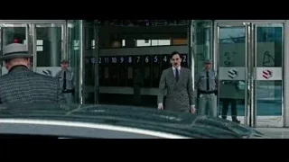 Man in suit with police at entrance — Now You See Me 2