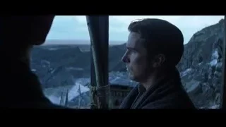 Man in dark coat looking out at mountains — Batman