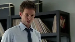 man in shirt and tie by bookshelf — Suits