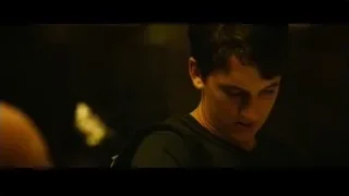 young man in black t-shirt in dimly lit room — Whiplash
