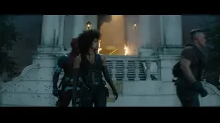 Woman in front of building with fire — Deadpool 2