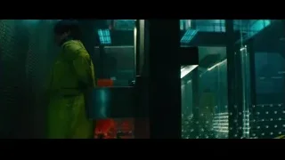 man in yellow jumpsuit looking at body — Deadpool 2