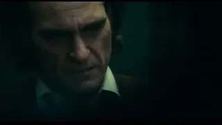 Man with serious expression in dimly lit room — Joker
