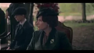 woman in green coat sitting in park — Peaky Blinders