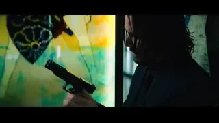 Man standing before graffiti window — John Wick: Chapter 4
