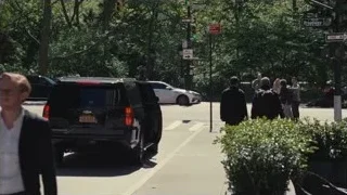 Man in suit walking on city street — Succession