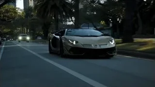 Lamborghini sports car driving on street at night — Sports Cars