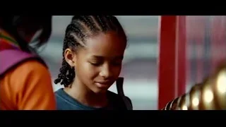 Young girl at red wall with Buddha statue — The Karate Kid