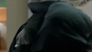 man in suit bending over cabinet — Suits