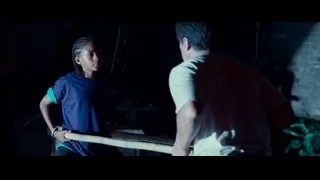 two men with wooden stick in dark room — The Karate Kid