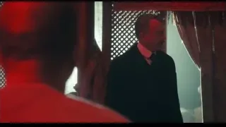 man in suit by window with red curtain — Peaky Blinders