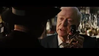 Elderly man in suit holding small figurine — Now You See Me
