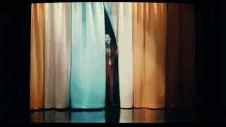 Man in red suit performing on stage — Joker