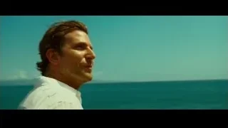 man standing on cliff overlooking ocean — Limitless