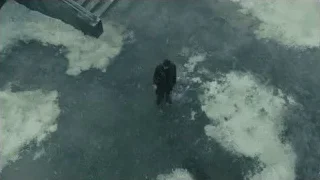 man walking in large water puddle — Blade Runner 2049