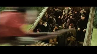 people in medieval clothes on boat with horn — Harry Potter and the Philosophers Stone