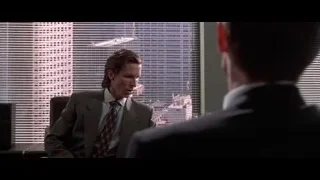 man in suit conversing in office with cityscape — American Psycho