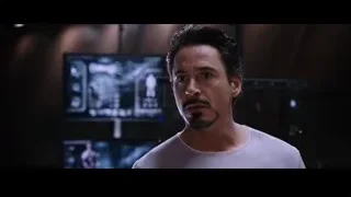 Robert Downey Jr. in dim room with screen — Iron Man