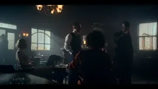 People in formal attire in dimly lit room — Peaky Blinders