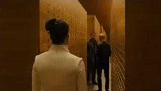 three people walking down long corridor — Blade Runner 2049