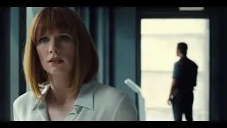 Woman and man with gun in hallway — Jurassic World