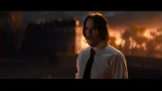 Man with beard by city skyline at sunset — John Wick: Chapter 4